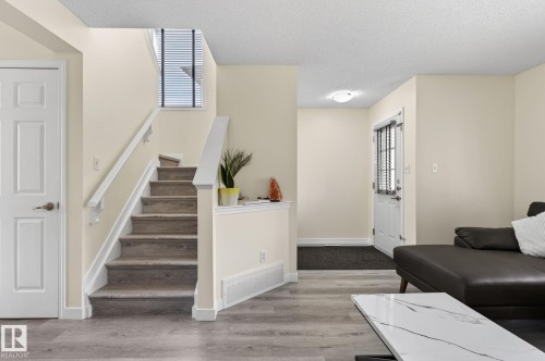 Staircase with wood-finish treads and white risers - 21244 90 Avenue, Edmonton, AB 