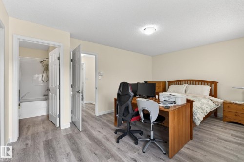 Spacious room with wood-finish flooring and neutral wall tones - 21244 90 Avenue, Edmonton, AB 