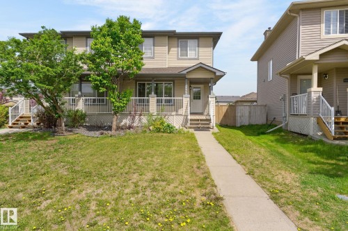 Two-story residence featuring light-colored siding and a covered front porch with white railings - 21244 90 Avenue, Edmonton, AB 