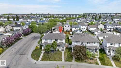 Two-story residence with a light-colored stucco exterior and dark shingle roof - 21244 90 Avenue, Edmonton, AB 