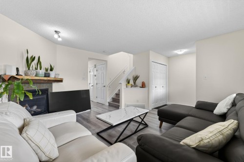 Spacious living area featuring light-toned walls and wood-finish flooring - 21244 90 Avenue, Edmonton, AB 