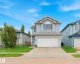 Two-story residential property featuring light blue siding and a light gray shingled roof - 3231 28A Avenue, Edmonton, AB 