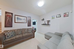 Living area featuring light wall paint, carpet flooring, and a flush-mount ceiling light - 