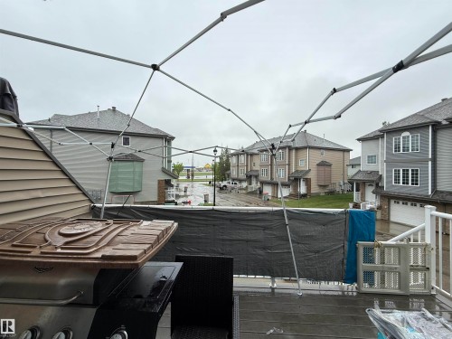 Exterior deck featuring composite decking, white railing, and horizontal siding - 41 5102 30 Avenue, Beaumont, AB 