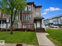 Townhome exterior featuring multi-toned siding, white trim, and a covered entryway - 41 5102 30 Avenue, Beaumont, AB 