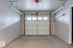 Finished garage interior with painted walls and a concrete floor - 