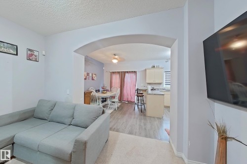 Arched doorway opening to dining area and kitchen - 41 5102 30 Avenue, Beaumont, AB 