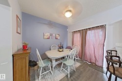 Dining area featuring wood-finish flooring and a light fixture - 