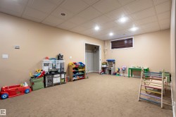 Spacious room featuring neutral carpeting and light-toned walls - 