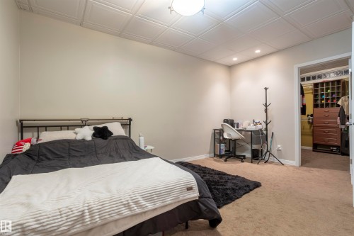 Bedroom featuring a textured ceiling, recessed lighting, and neutral-toned walls - 1441 Highwood Boulevard, Devon, AB 