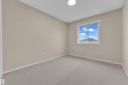 Neutral-toned walls complement plush carpeting - 