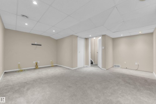 Expansive carpeted room featuring recessed lighting and a dropped ceiling - 3134 30 Avenue Nw, Edmonton, AB 
