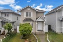 Two-story residence featuring light-toned horizontal siding and dark shingle roofing - 3134 30 Avenue Nw, Edmonton, AB 
