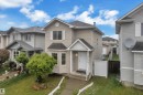 Two-story residence featuring light-toned siding, a covered front entry, and a bay window on the main level - 3134 30 Avenue Nw, Edmonton, AB 