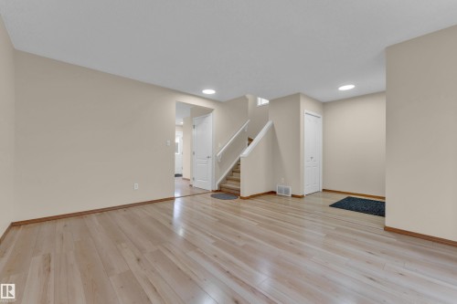 Light wood-finish flooring extending throughout the main level - 3134 30 Avenue Nw, Edmonton, AB 