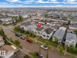 Residential neighborhood featuring detached homes with various roof styles and established landscaping - 