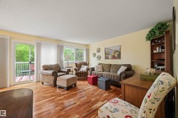 Hardwood flooring throughout, with a sliding glass door opening to an outdoor balcony - 