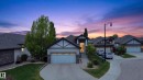 Contemporary-style residence featuring a two-car garage, stone and siding exterior, prominent gables, and a mature tree providing natural landscaping - 624 Cantor Landing Landing, Edmonton, AB 