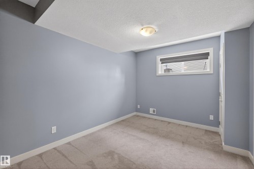 Light blue painted walls with white trim and neutral carpeting - 624 Cantor Landing Landing, Edmonton, AB 
