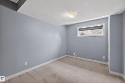 Light blue painted walls with white trim and neutral carpeting - 