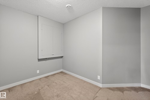 Interior space featuring light gray walls, white baseboards, and tan carpet flooring - 624 Cantor Landing Landing, Edmonton, AB 