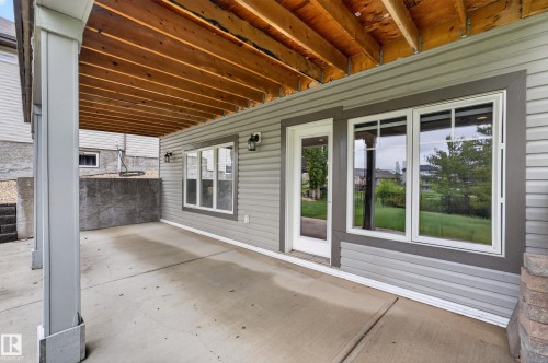 Covered concrete patio with exposed wood ceiling joists - 624 Cantor Landing Landing, Edmonton, AB 