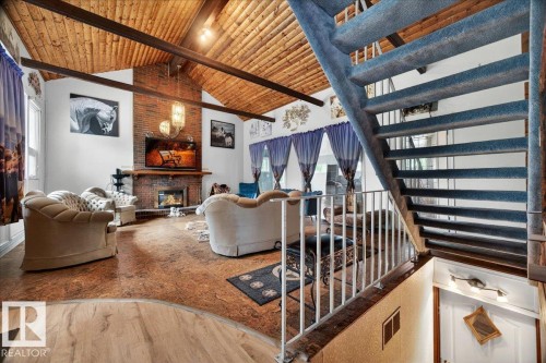 Vaulted ceiling featuring exposed wood beams and planking - 140 50047 Rge Rd 244, Rural Leduc County, AB 