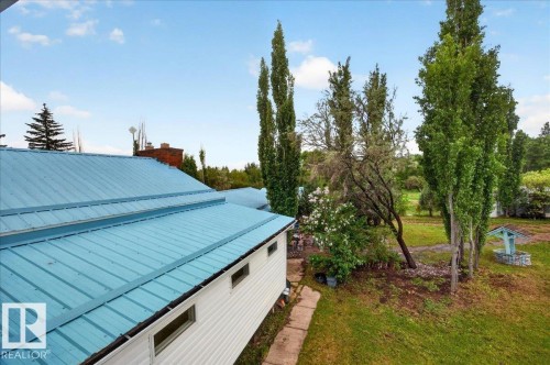 Blue metal roof on a white siding structure - 140 50047 Rge Rd 244, Rural Leduc County, AB 