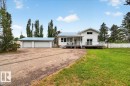 White exterior with light blue metal roofing - 140 50047 Rge Rd 244, Rural Leduc County, AB 