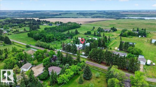 Expansive property featuring a mix of mature trees, open green spaces, and cultivated fields - 140 50047 Rge Rd 244, Rural Leduc County, AB 