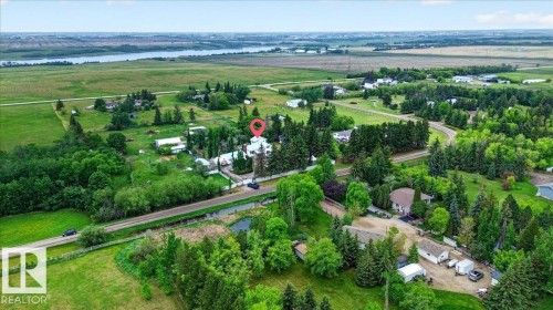 Expansive property featuring mature trees and lush green landscaping - 140 50047 Rge Rd 244, Rural Leduc County, AB 