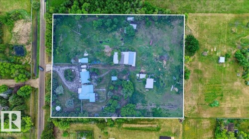 Expansive property featuring multiple structures, verdant foliage, and open land - 140 50047 Rge Rd 244, Rural Leduc County, AB 