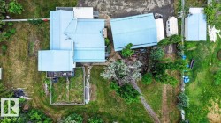 Aerial perspective showcasing the property's layout with multiple structures and expansive grounds - 
