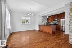 Open concept living space featuring wood-finish flooring throughout - 