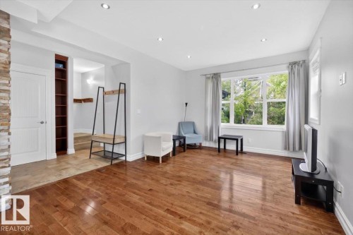 Hardwood flooring extends through this bright living area with recessed lighting - 10958 88 Avenue, Edmonton, AB 