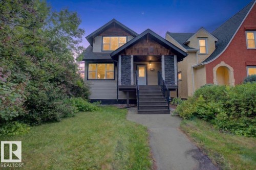 Multi-level exterior featuring light-toned siding and dark trim - 10958 88 Avenue, Edmonton, AB 