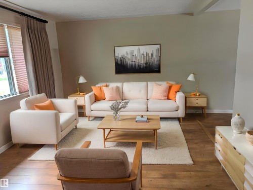Living area featuring wood-finish flooring, a neutral wall color, and window treatments - 9443 75 Street, Edmonton, AB 