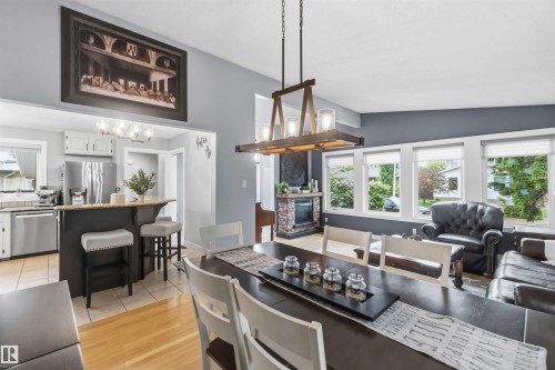 Open-concept living area featuring a vaulted ceiling and a prominent dining space - 11431 144 Avenue, Edmonton, AB 