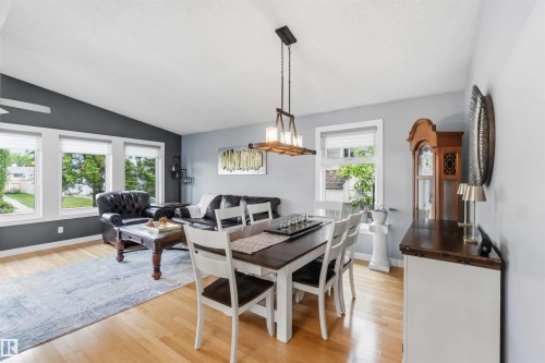 Open-concept living and dining area featuring wood-finish flooring - 11431 144 Avenue, Edmonton, AB 