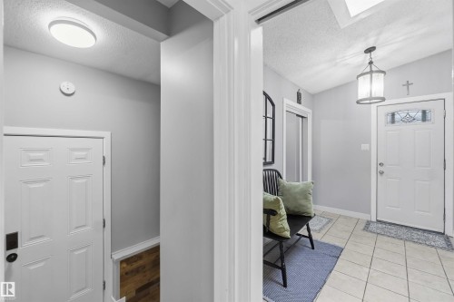 Entryway featuring ceramic tile flooring and a decorative door with an ornate glass insert - 11431 144 Avenue, Edmonton, AB 