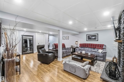 Spacious finished room featuring wood-finish flooring and recessed lighting - 11431 144 Avenue, Edmonton, AB 