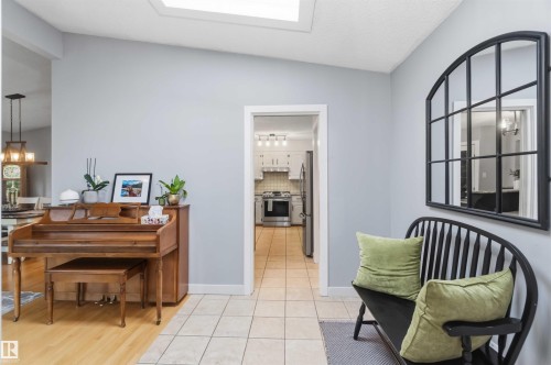 Foyer featuring a skylight, tile flooring, and light gray wall paint - 11431 144 Avenue, Edmonton, AB 