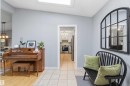 Foyer featuring a skylight, tile flooring, and light gray wall paint - 11431 144 Avenue, Edmonton, AB 