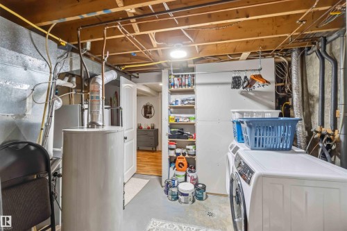 Basement utility area featuring exposed joists and concrete walls - 11431 144 Avenue, Edmonton, AB 