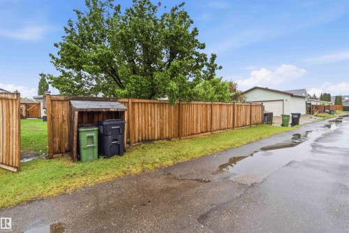 Wood privacy fencing with a built-in refuse enclosure - 11431 144 Avenue, Edmonton, AB 
