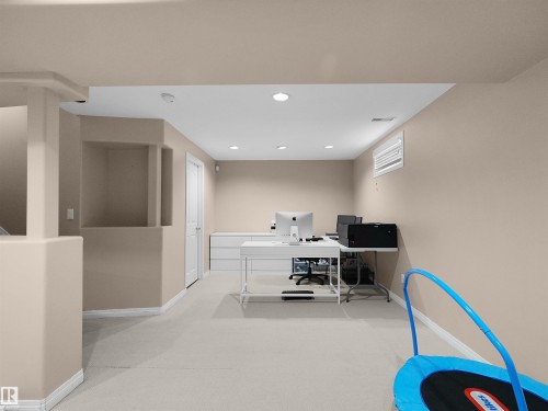 Carpeted room with recessed lighting, light beige wall paint, white trim, and a white door - 208 Ferguson Place, Edmonton, AB 