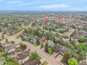 Expansive residential area featuring numerous detached homes with mature landscaping and a mountainous backdrop - 208 Ferguson Place, Edmonton, AB 