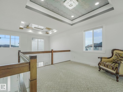 Spacious upper-level landing with carpet flooring and multiple windows - 3101 Pelerin Crescent, Beaumont, AB 