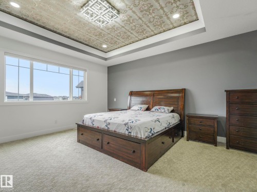 Tray ceiling with ornate wallpaper insert and recessed lighting - 3101 Pelerin Crescent, Beaumont, AB 