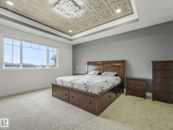 Tray ceiling with ornate wallpaper insert and recessed lighting - 